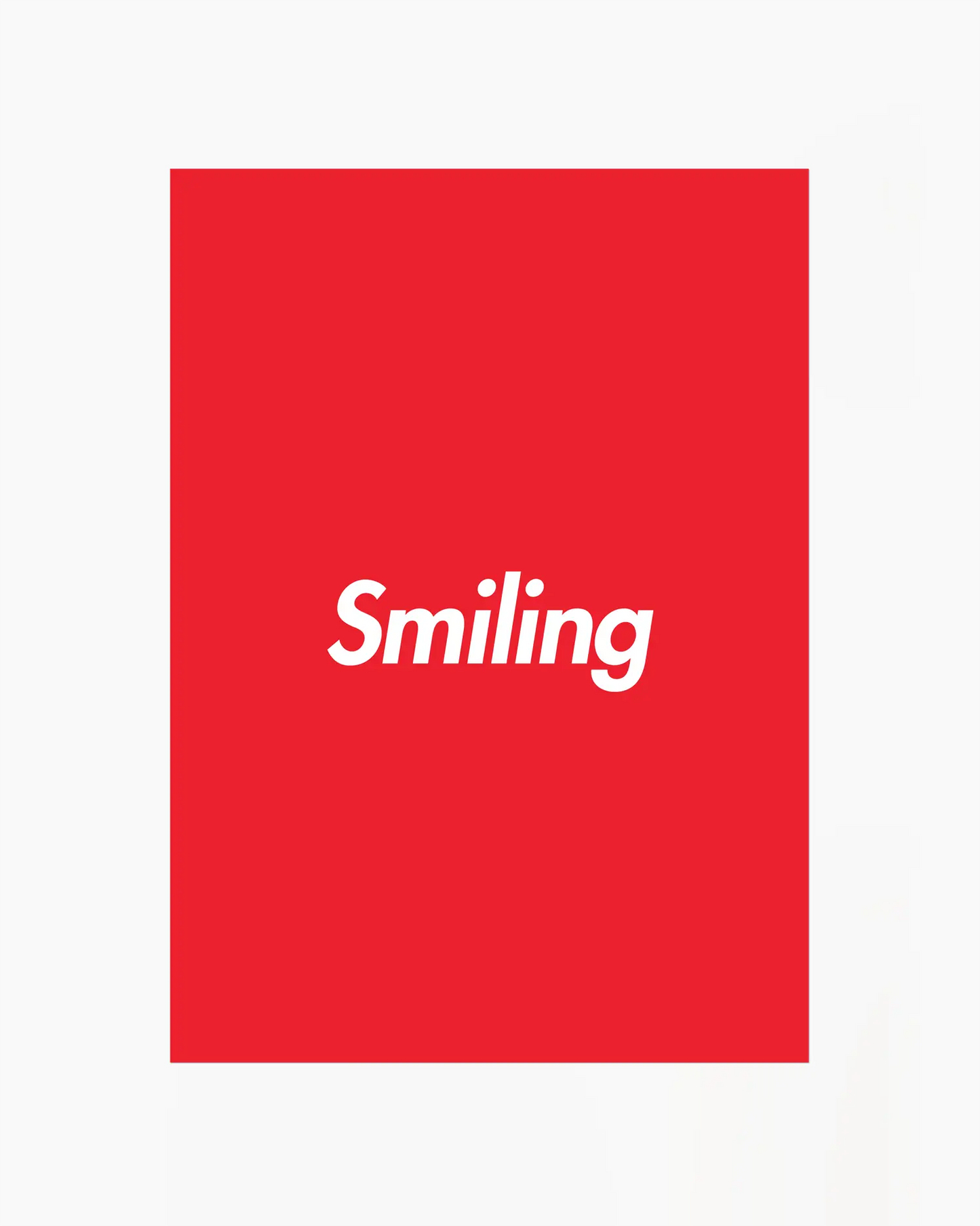 Red poster with 'Smiling' written in white