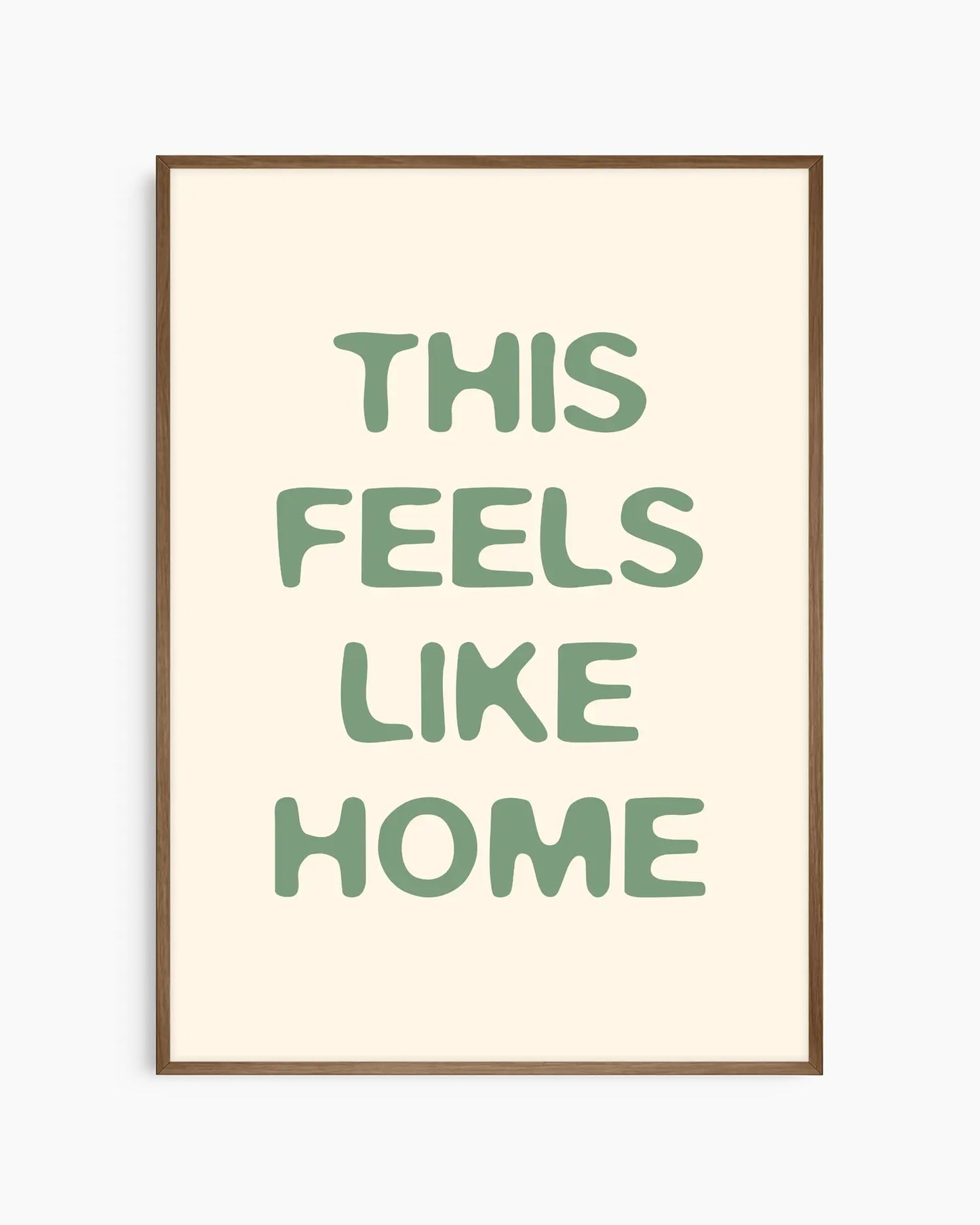 Nursery poster with the text 'This feels like home' written in green, inserted in a dark oak frame