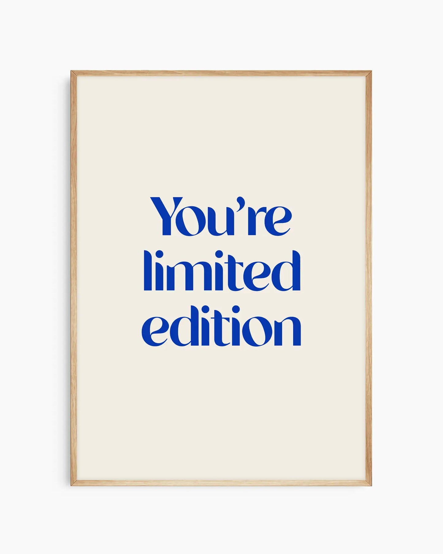Nursery poster with 'You're limited edition' text in blue framed in an oak frame