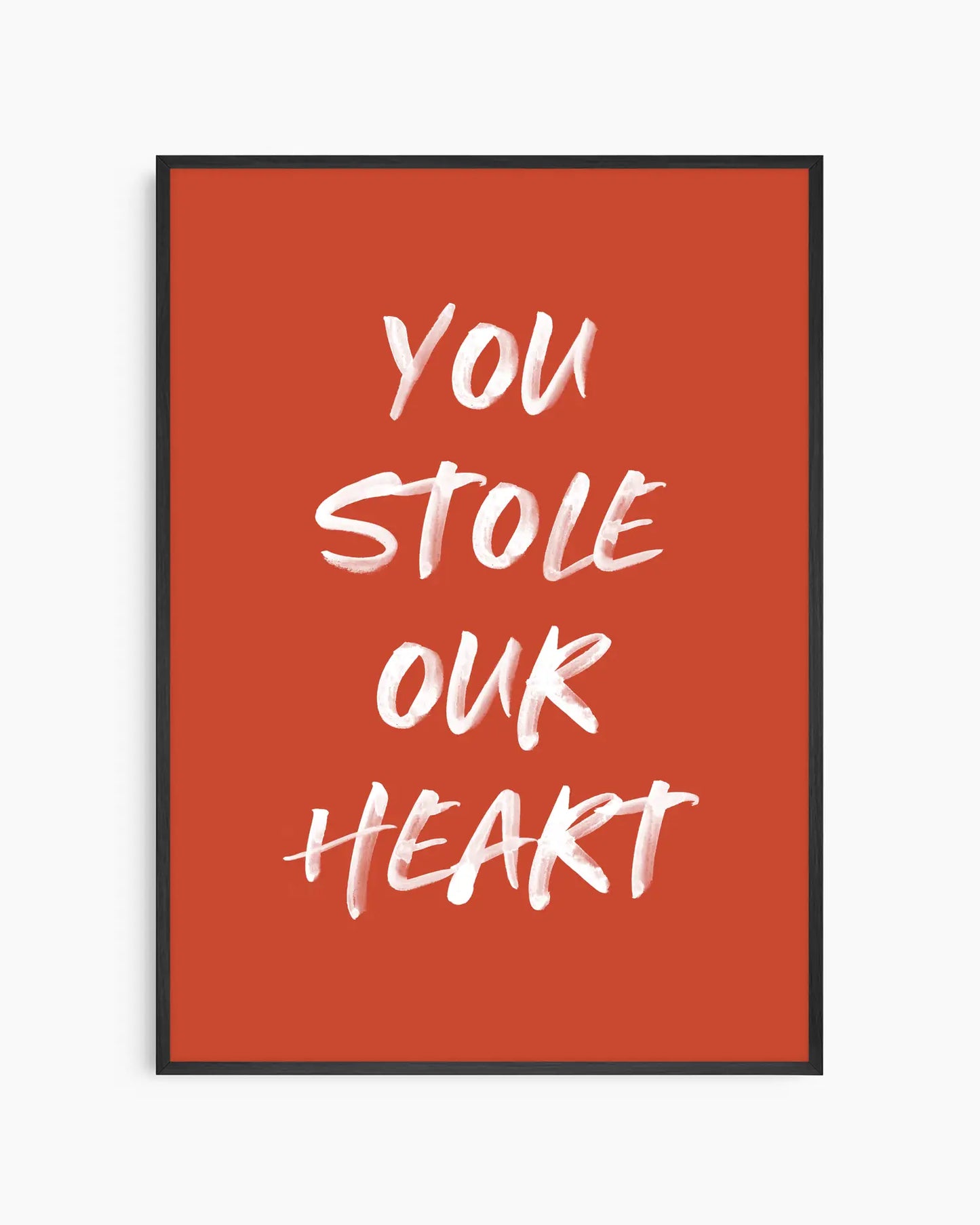 Nursery poster with white text 'You stole our heart' on a red background. Black frame.
