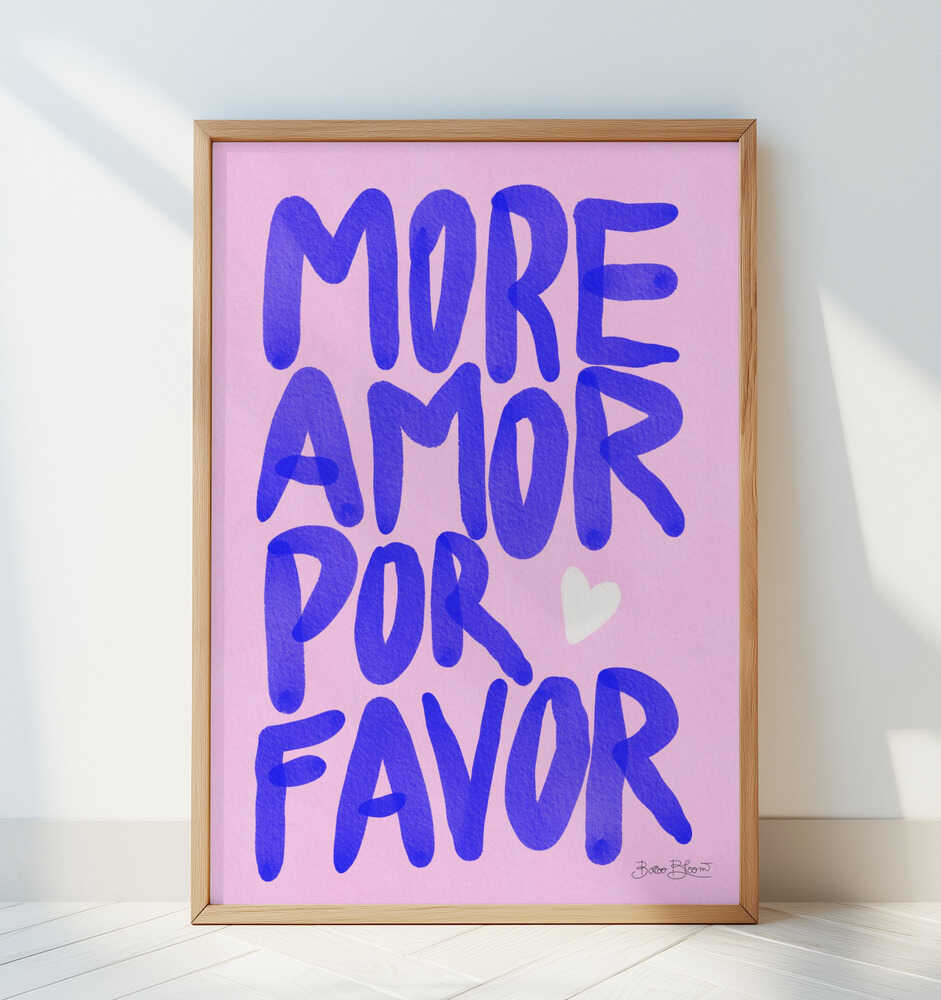 Framed nursery poster with purple text 'MORE AMOR POR FAVOR' leaning against a white wall.