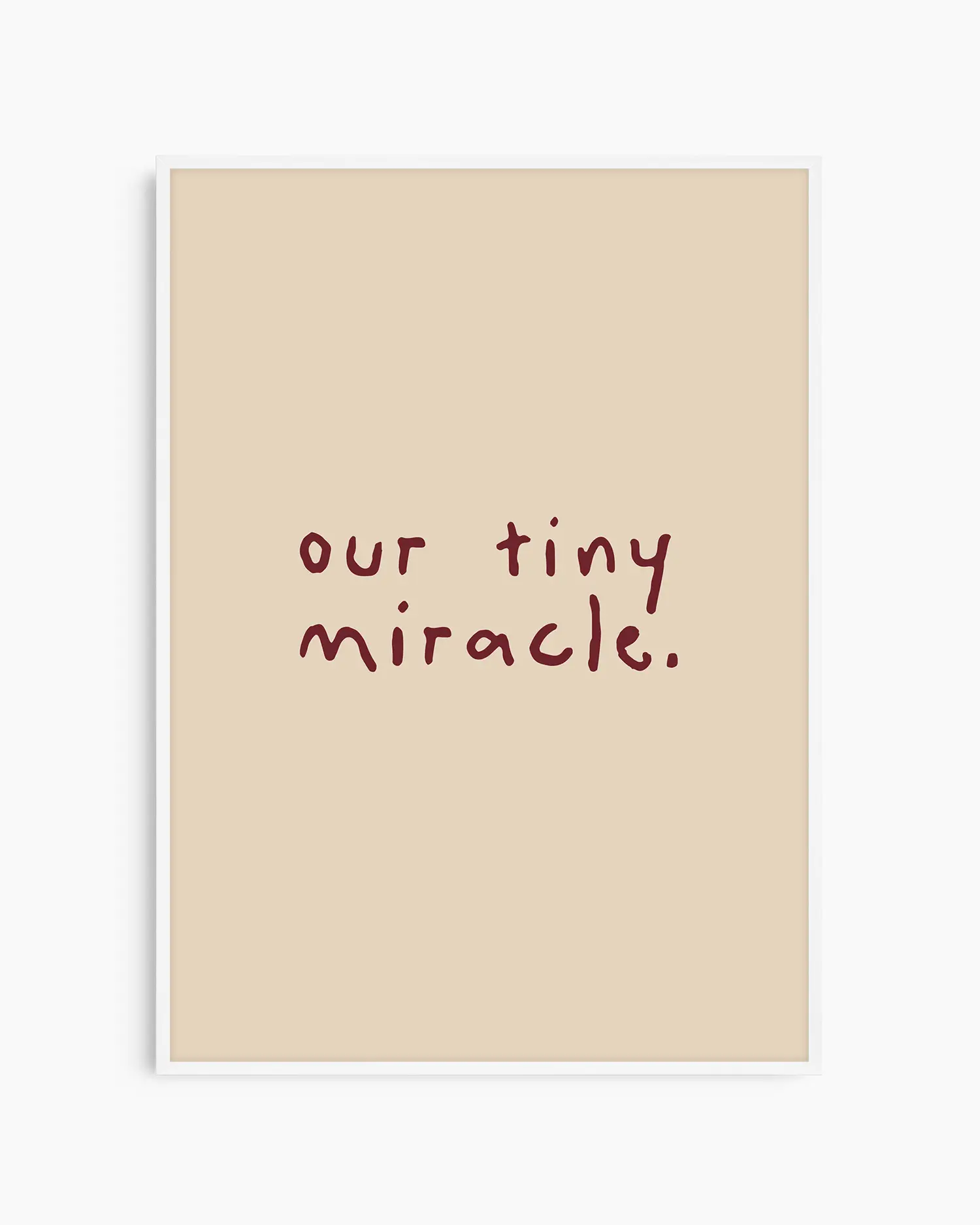 Beige nursery poster with 'our tiny miracle.' text in brown framed in a white frame.