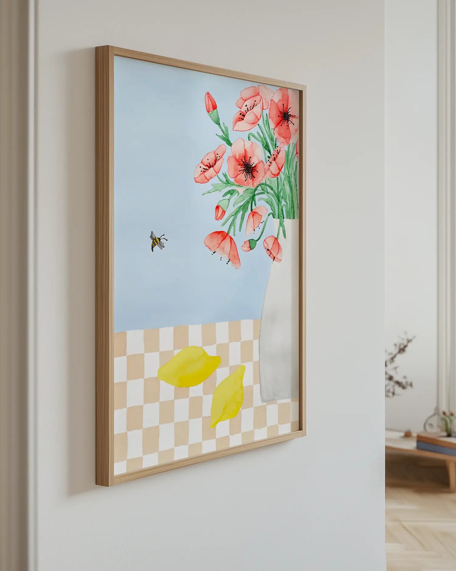 Framed artwork with flowers and lemons on a wall