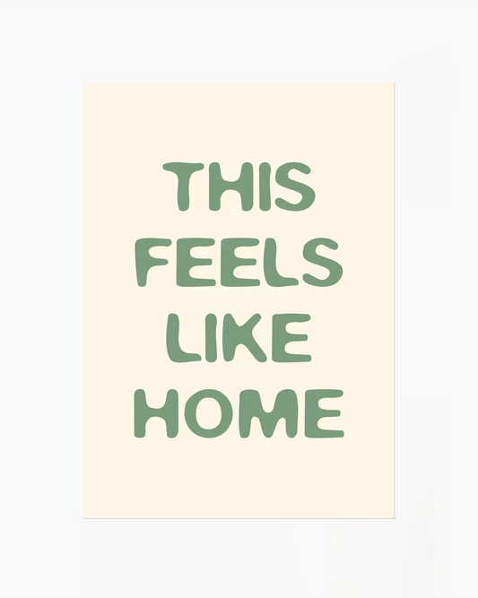Nursery poster with the text 'This feels like home' written in green