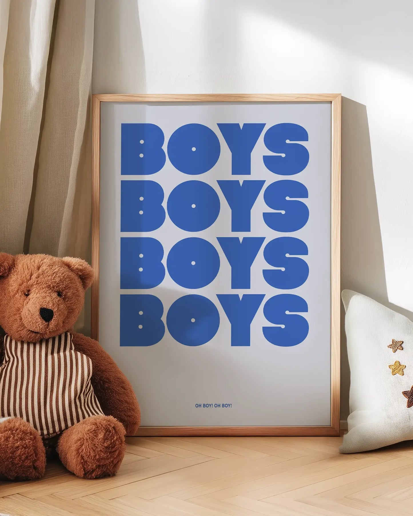Artwork with 'BOYS BOYS BOYS BOYS' text next to a teddy bear on a wooden floor.