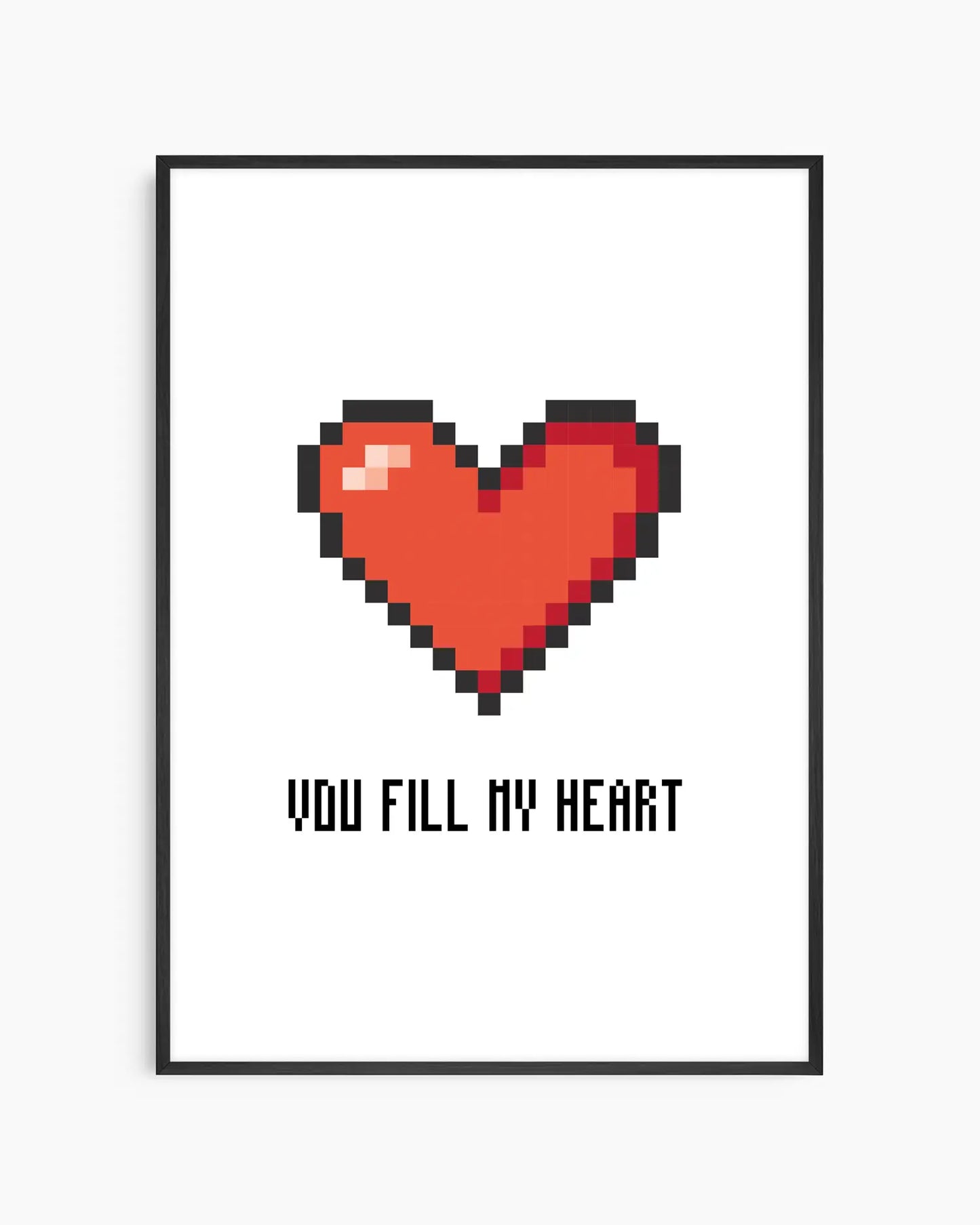Nursery poster with a red pixel heart and the text 'You Fill My Heart' text on a white background, framed in a black wooden frame.