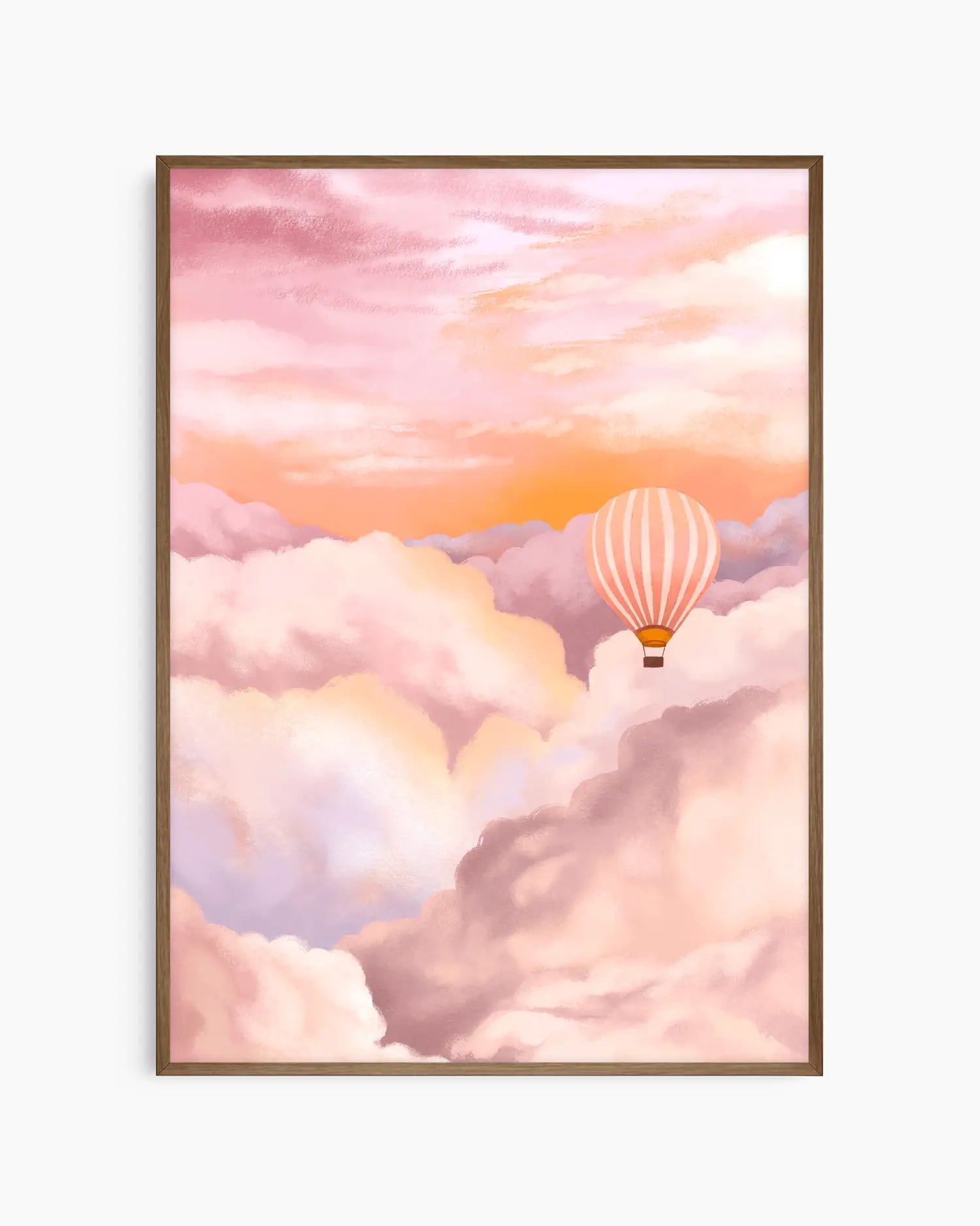 Framed artwork of a hot air balloon in a pink and orange sky with clouds.