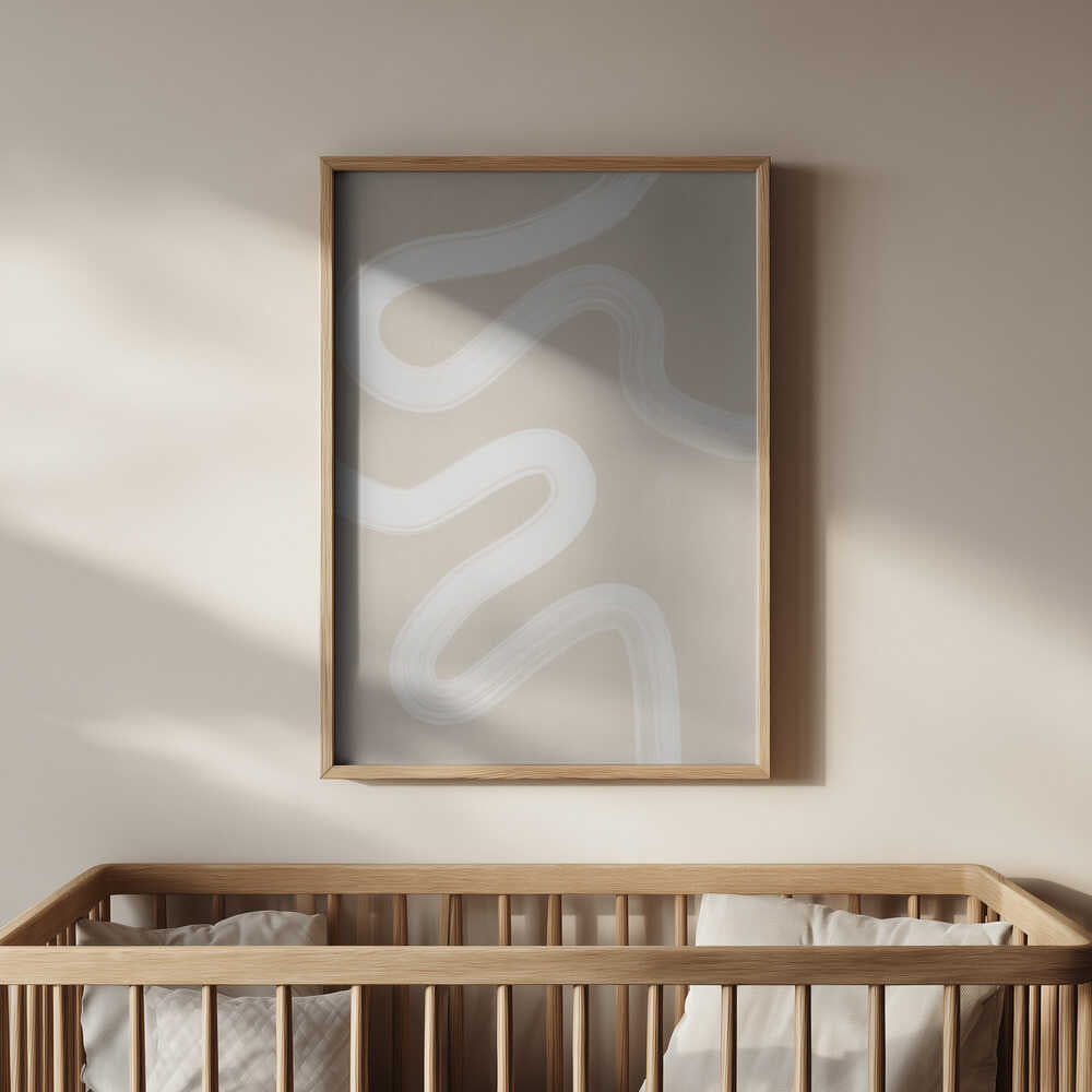 Minimalist beige art print with white wavy lines, framed in light wood and hanging above a baby’s crib. A soothing and elegant wall decor piece that adds warmth and calm to a modern nursery.