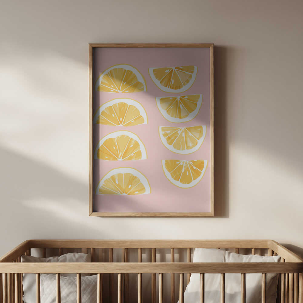 Framed poster of orange slices on a pink background above the baby's crib
